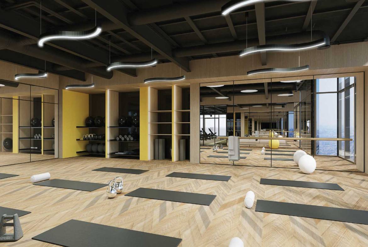 Yoga and pilates studio with mirrors, mats and city view windows