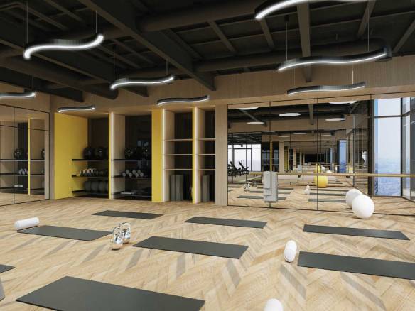 Yoga and pilates studio with mirrors, mats and city view windows