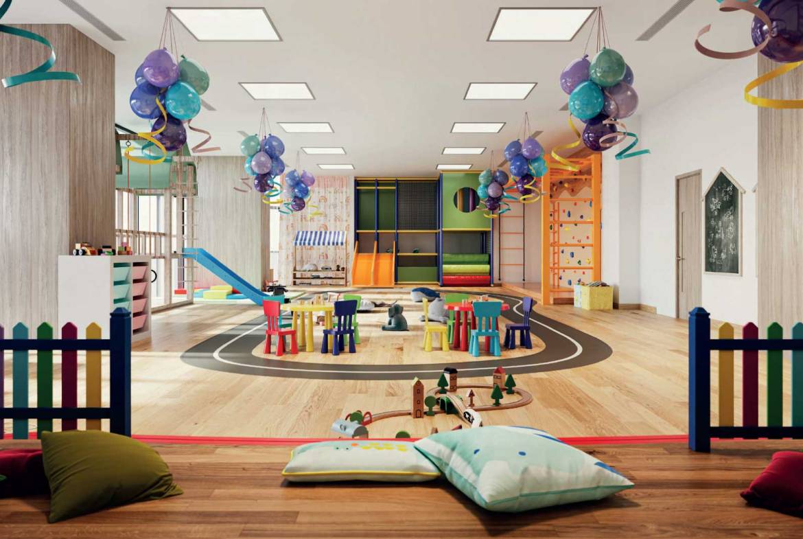 Colorful indoor kids’ play area with slides, balloons, and activity tables