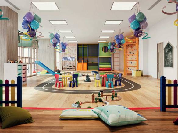 Colorful indoor kids’ play area with slides, balloons, and activity tables