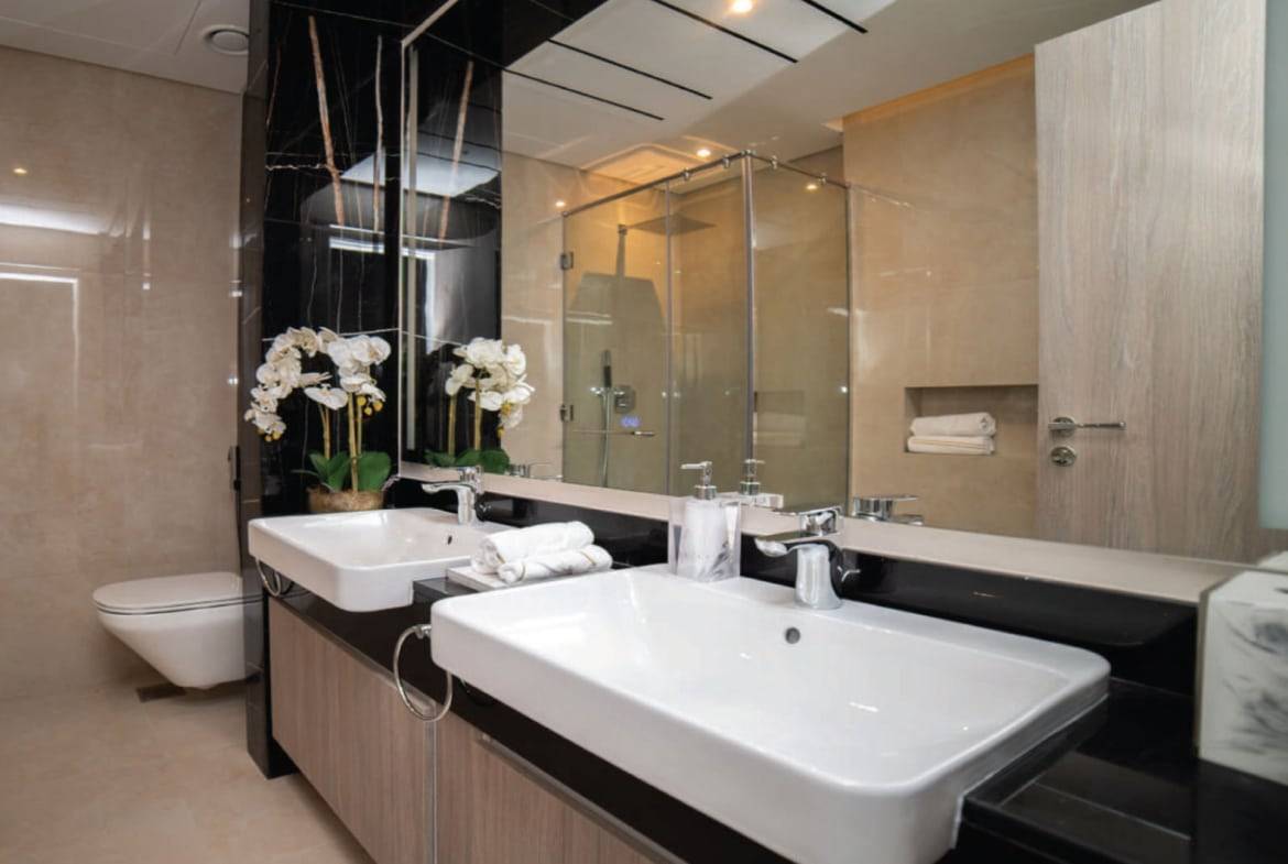 Luxury bathroom with double vanity and glass shower enclosure