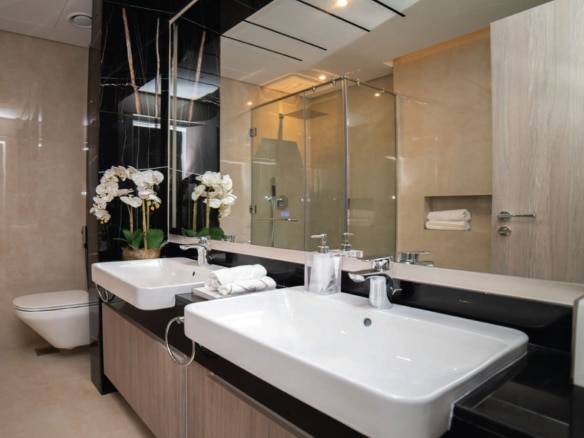 Luxury bathroom with double vanity and glass shower enclosure