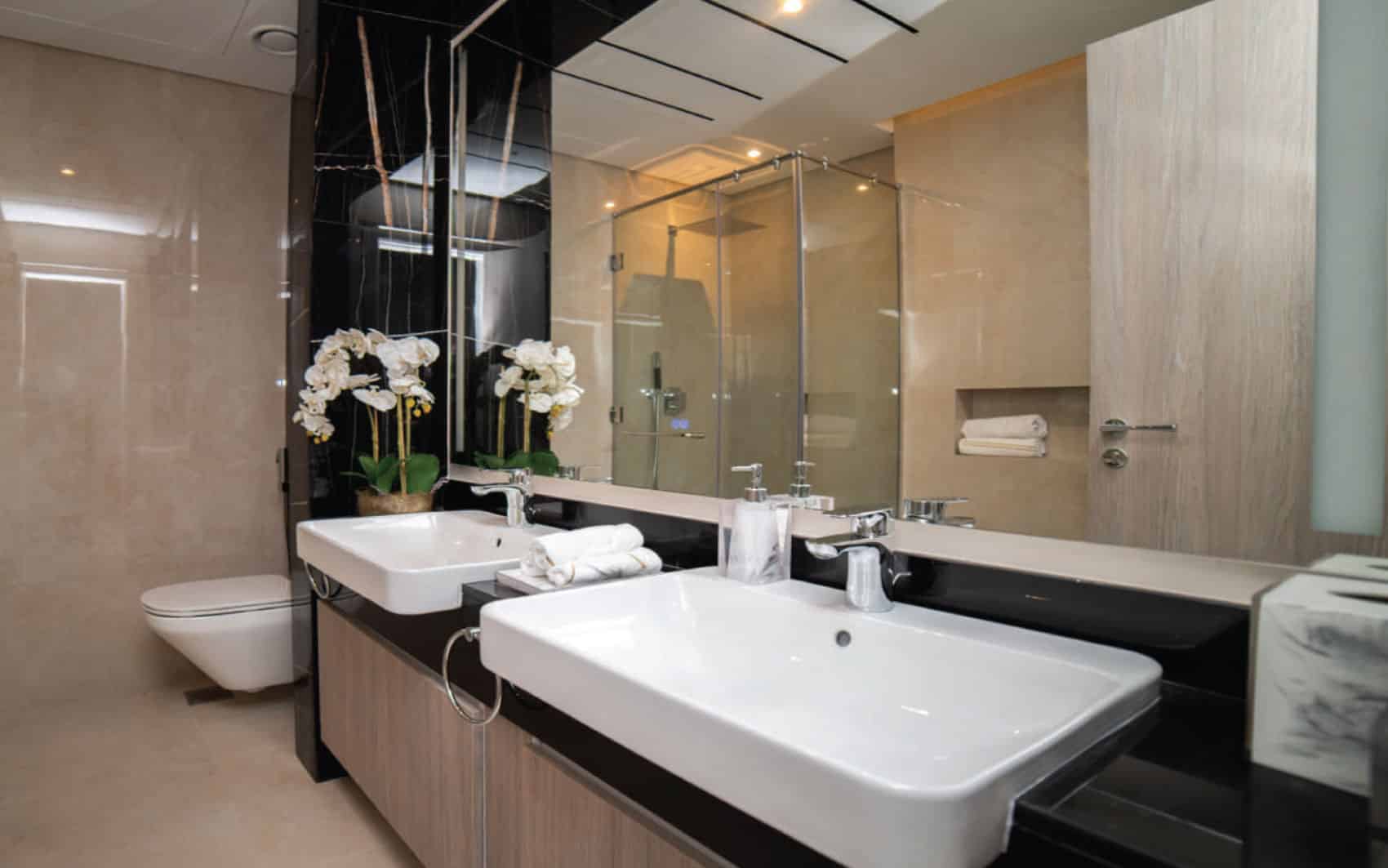 Luxury bathroom with double vanity and glass shower enclosure