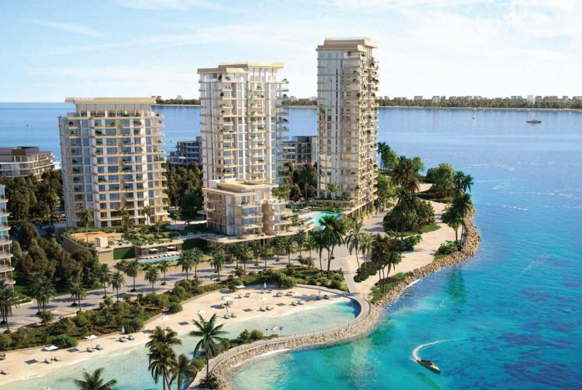 Luxury beachfront residential towers with palm trees and blue sea