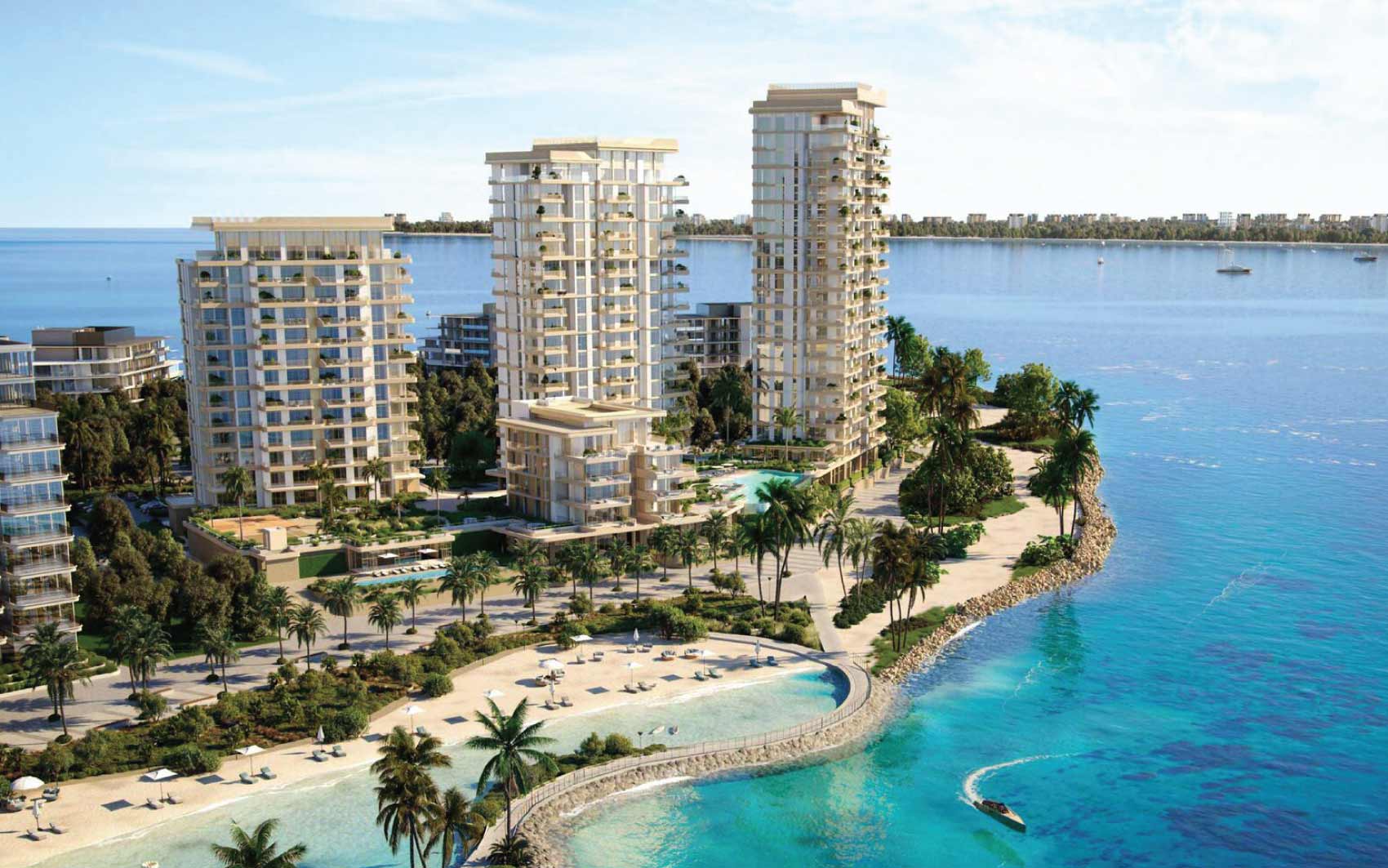 Luxury beachfront residential towers with palm trees and blue sea