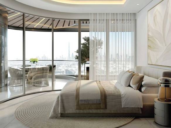 Elegant bedroom with curved glass wall, balcony seating, and panoramic Dubai skyline view
