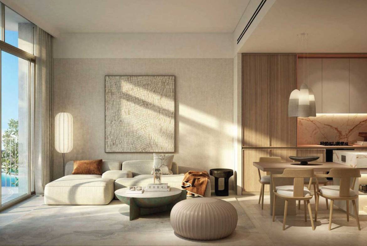 Bright open-plan living and dining area with neutral decor and marble-accented kitchen