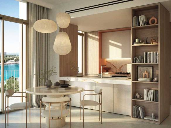 Modern kitchen with round dining table, built-in shelving, and panoramic sea view