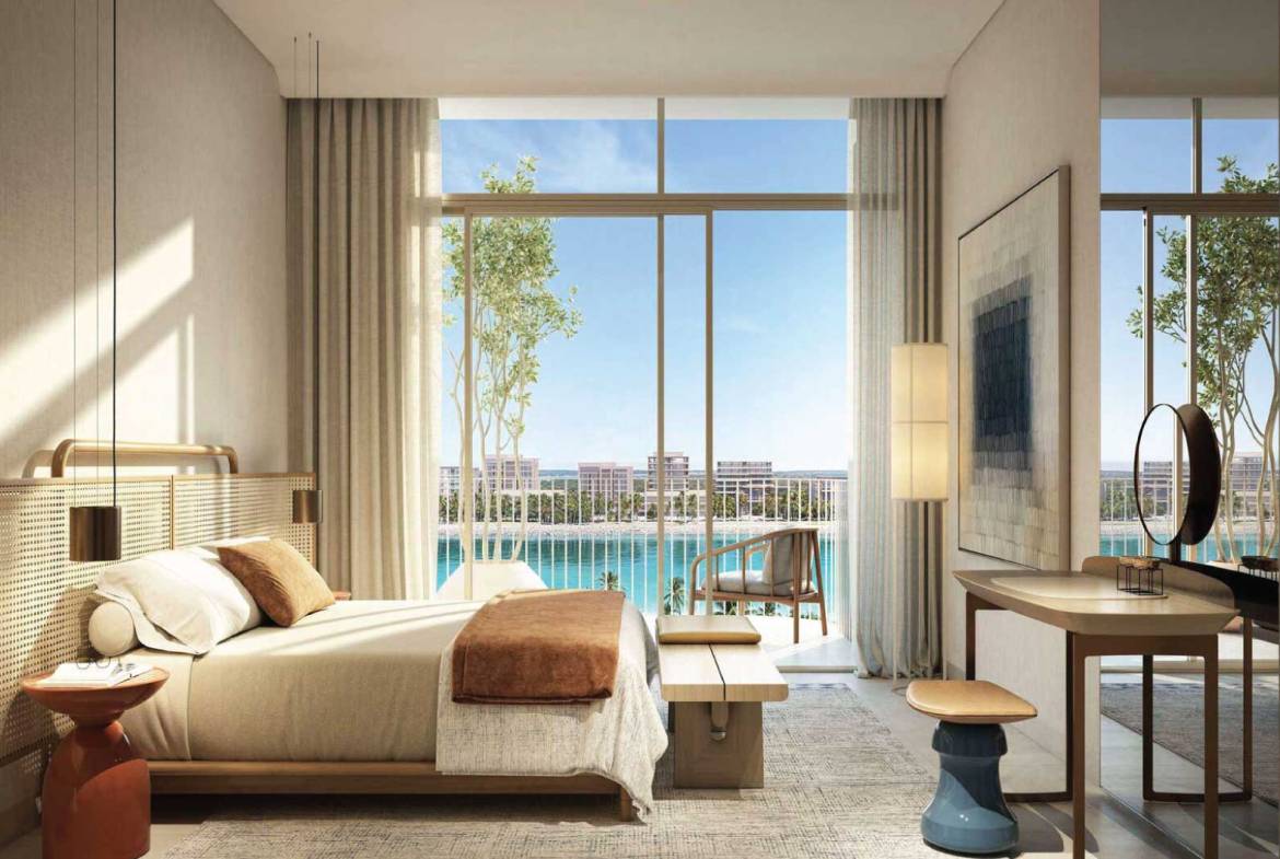 Elegant bedroom with floor-to-ceiling windows overlooking lagoon views