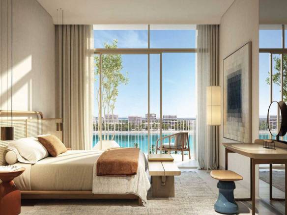 Elegant bedroom with floor-to-ceiling windows overlooking lagoon views