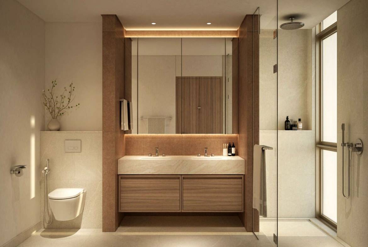 Luxury bathroom with double vanity, glass shower, and warm ambient lighting