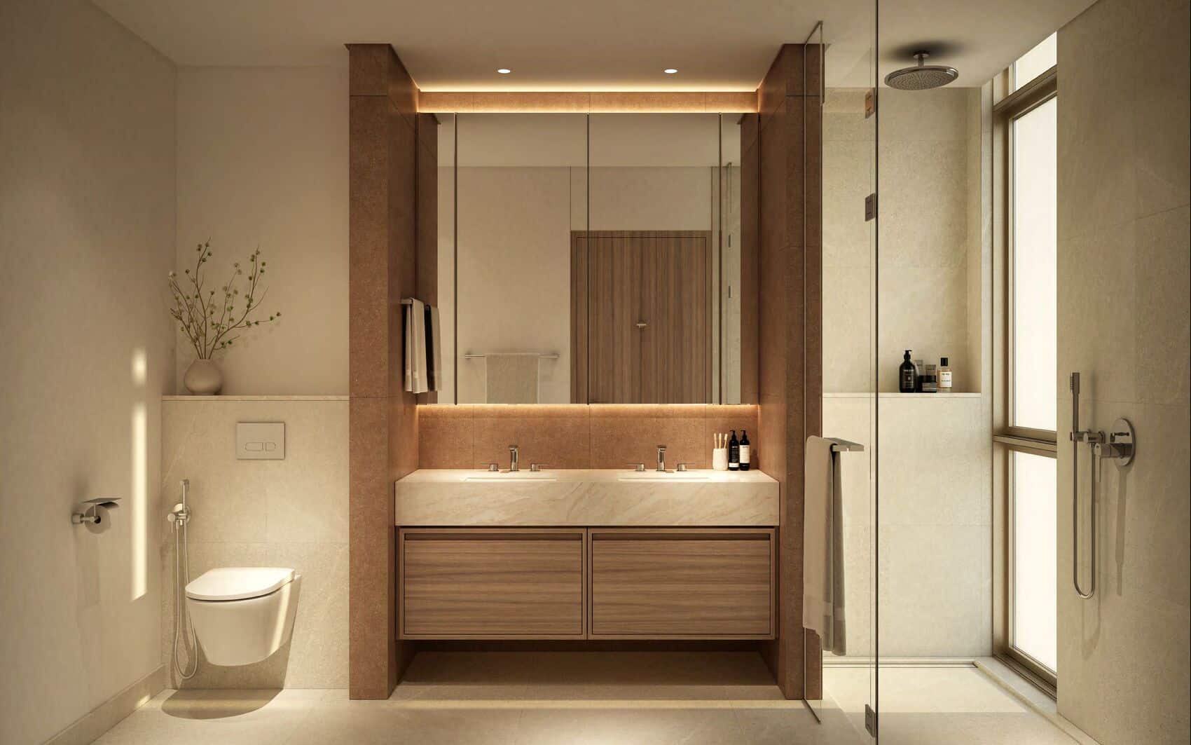 Luxury bathroom with double vanity, glass shower, and warm ambient lighting