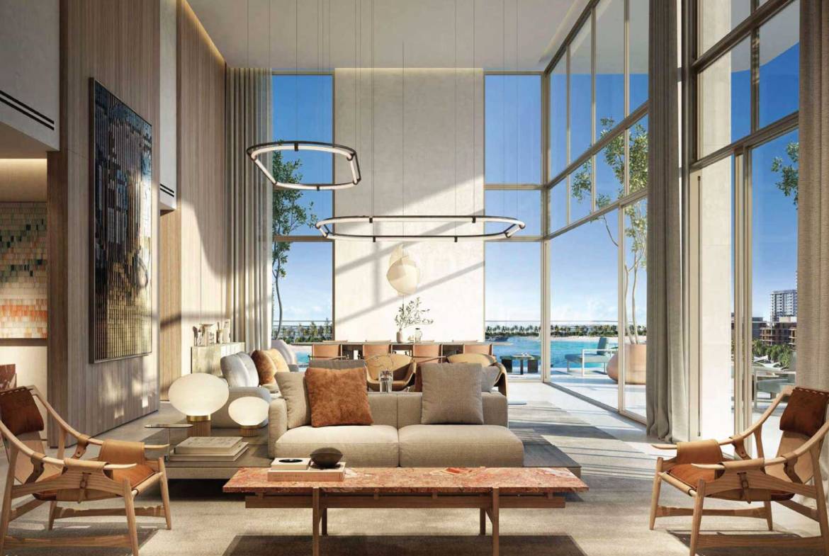 Modern living room with high ceilings, large windows, and oceanfront view