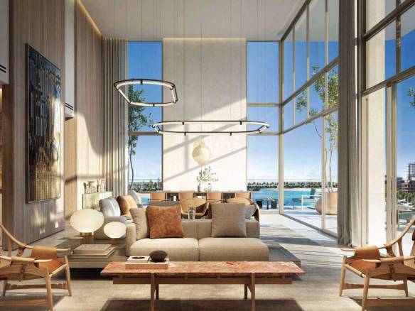 Modern living room with high ceilings, large windows, and oceanfront view