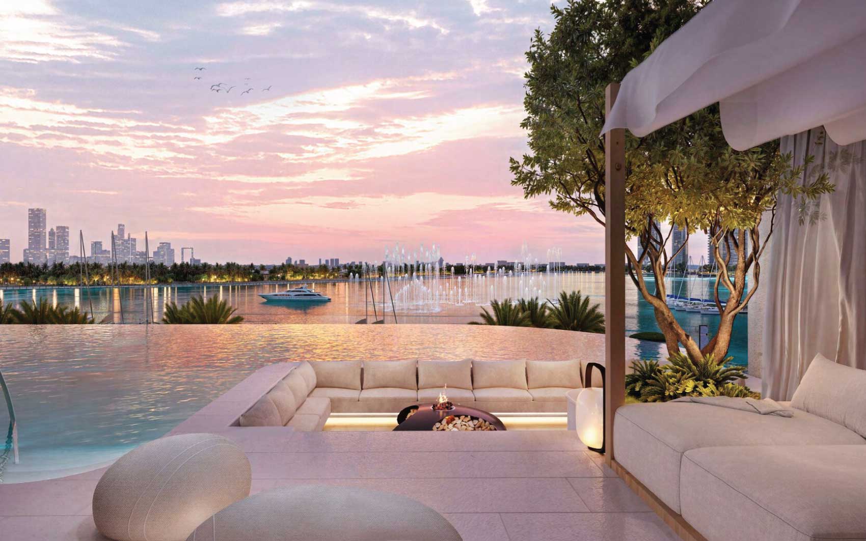 Luxury waterfront terrace with infinity pool, sunken seating, and city skyline at sunset