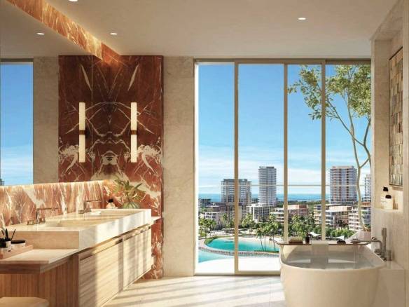 Elegant bathroom with marble accents, dual sinks, and ocean view from large windows