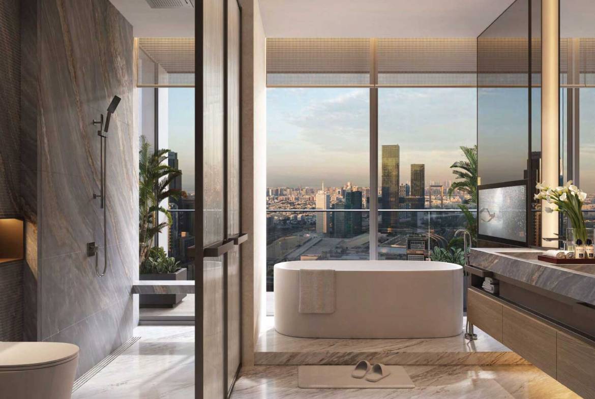 Luxury bathroom with freestanding tub, marble finishes, and panoramic city skyline view