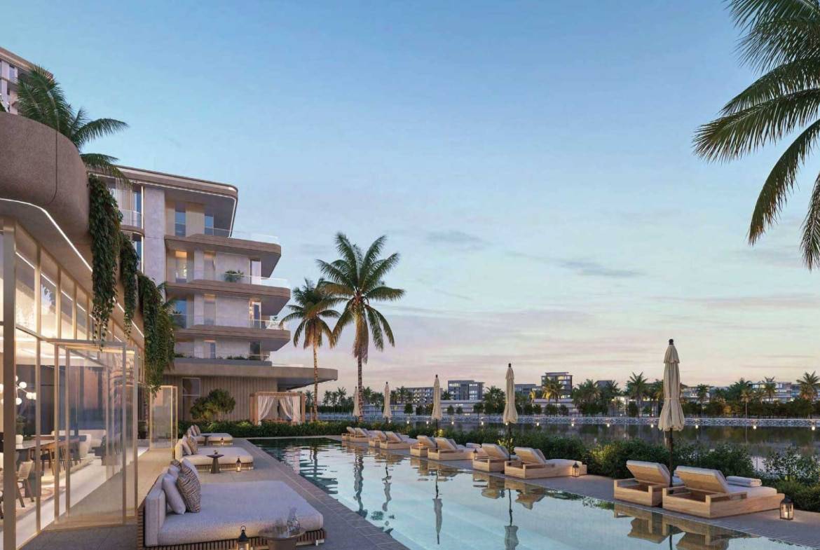 Resort-style poolside lounge with palm trees and waterfront views