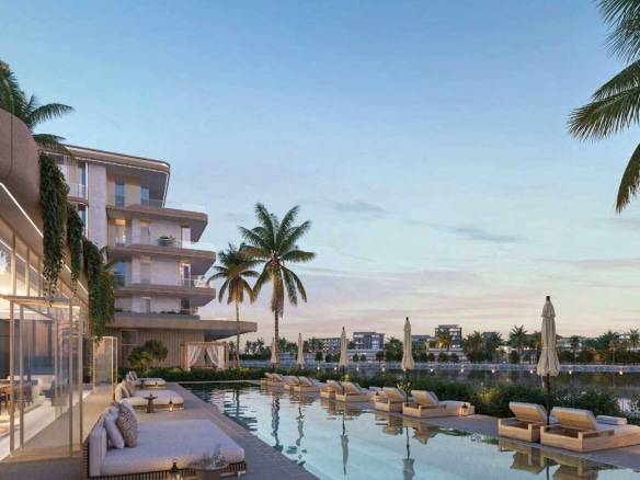 Resort-style poolside lounge with palm trees and waterfront views