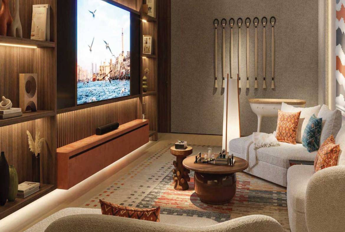 Cozy home theater room with large screen, designer lighting, and comfortable seating