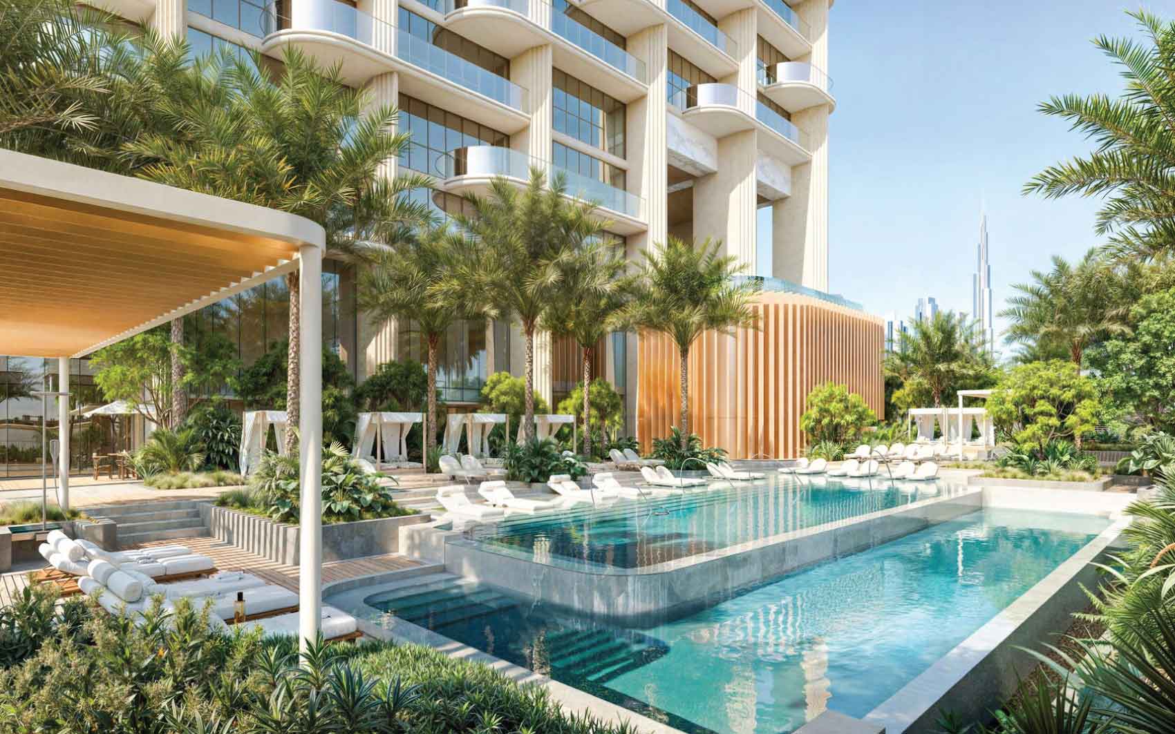 Resort-style outdoor pool with sun loungers, cabanas, and lush landscaping at modern residential complex