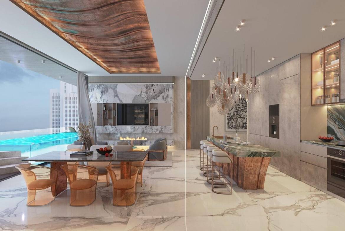 Luxury open-plan kitchen and dining area with marble finishes, designer lighting, and infinity pool view