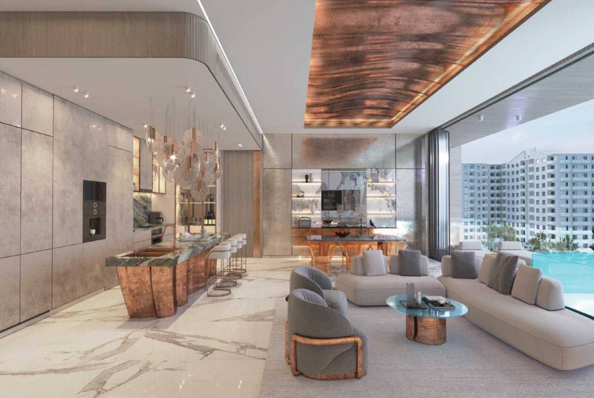 Elegant living room with copper-accented kitchen island and infinity pool view