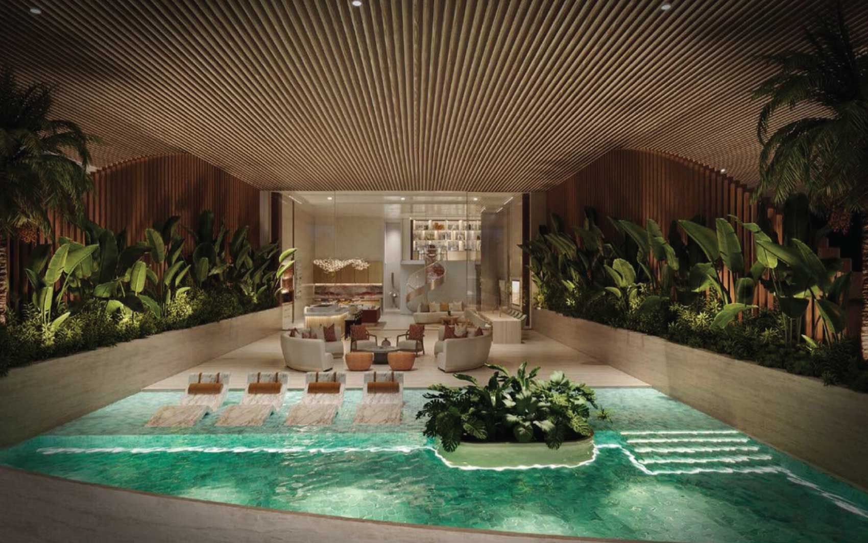 Indoor luxury pool with tropical plants and modern lounge area