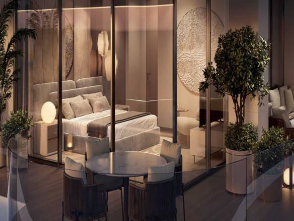 Luxury bedroom with floor-to-ceiling glass, private balcony, and stylish seating area