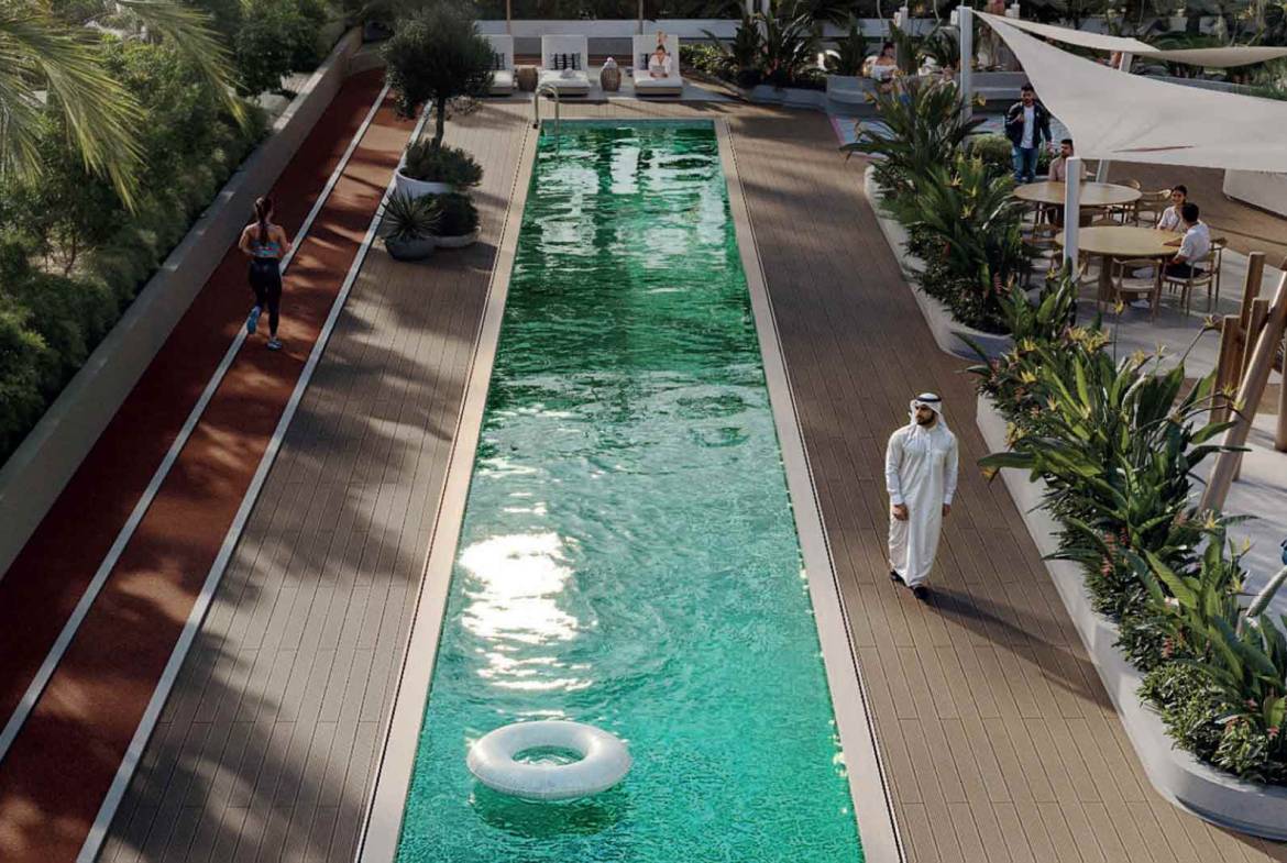 Outdoor lap pool with running track, tropical landscaping, and leisure seating areas