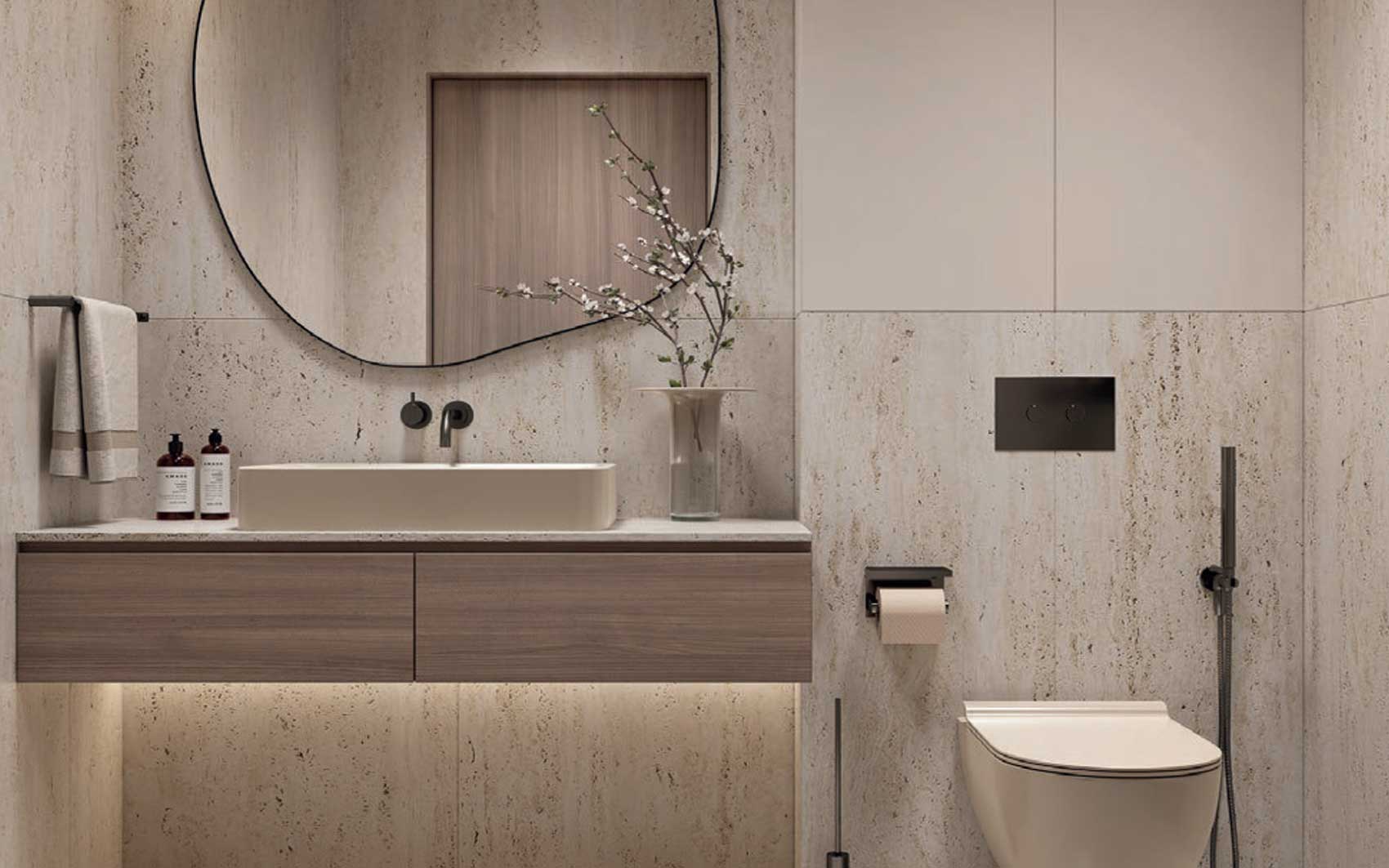 Modern bathroom with floating vanity, round mirror, and stone walls