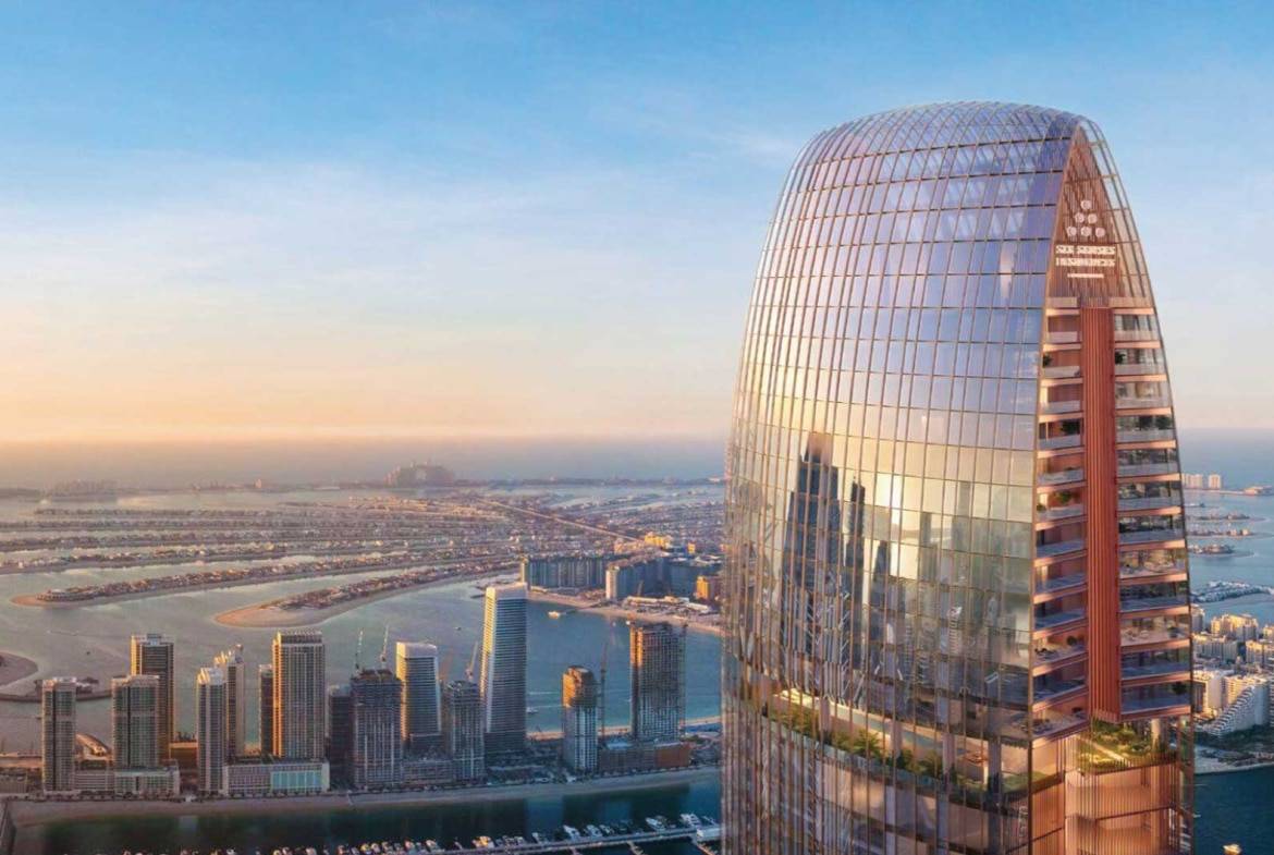Iconic high-rise skyscraper in Dubai overlooking Palm Jumeirah at sunset