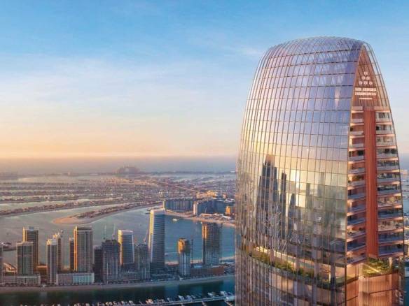 Iconic high-rise skyscraper in Dubai overlooking Palm Jumeirah at sunset