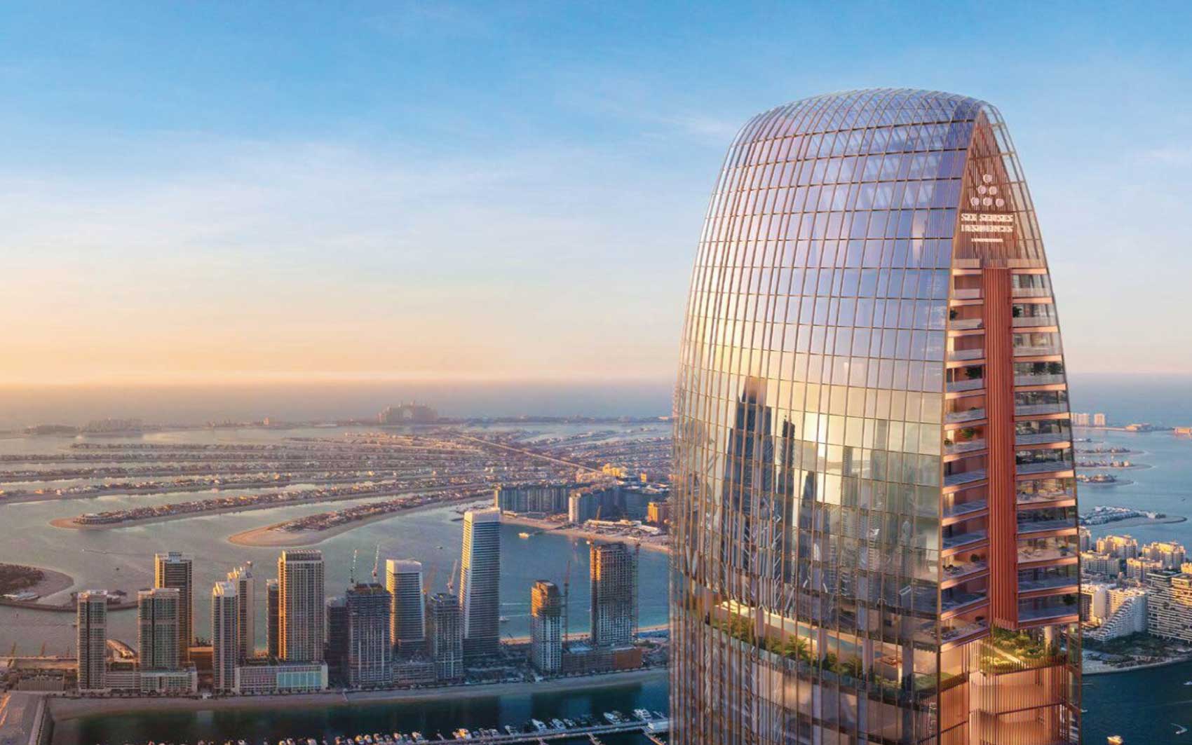 Iconic high-rise skyscraper in Dubai overlooking Palm Jumeirah at sunset