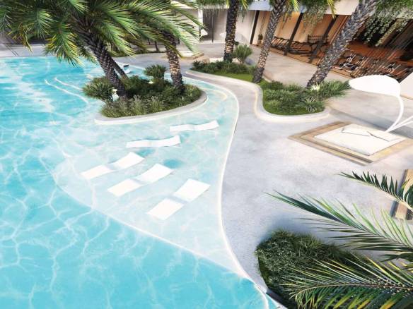 Luxury resort-style pool with palm trees and sun loungers in shallow water