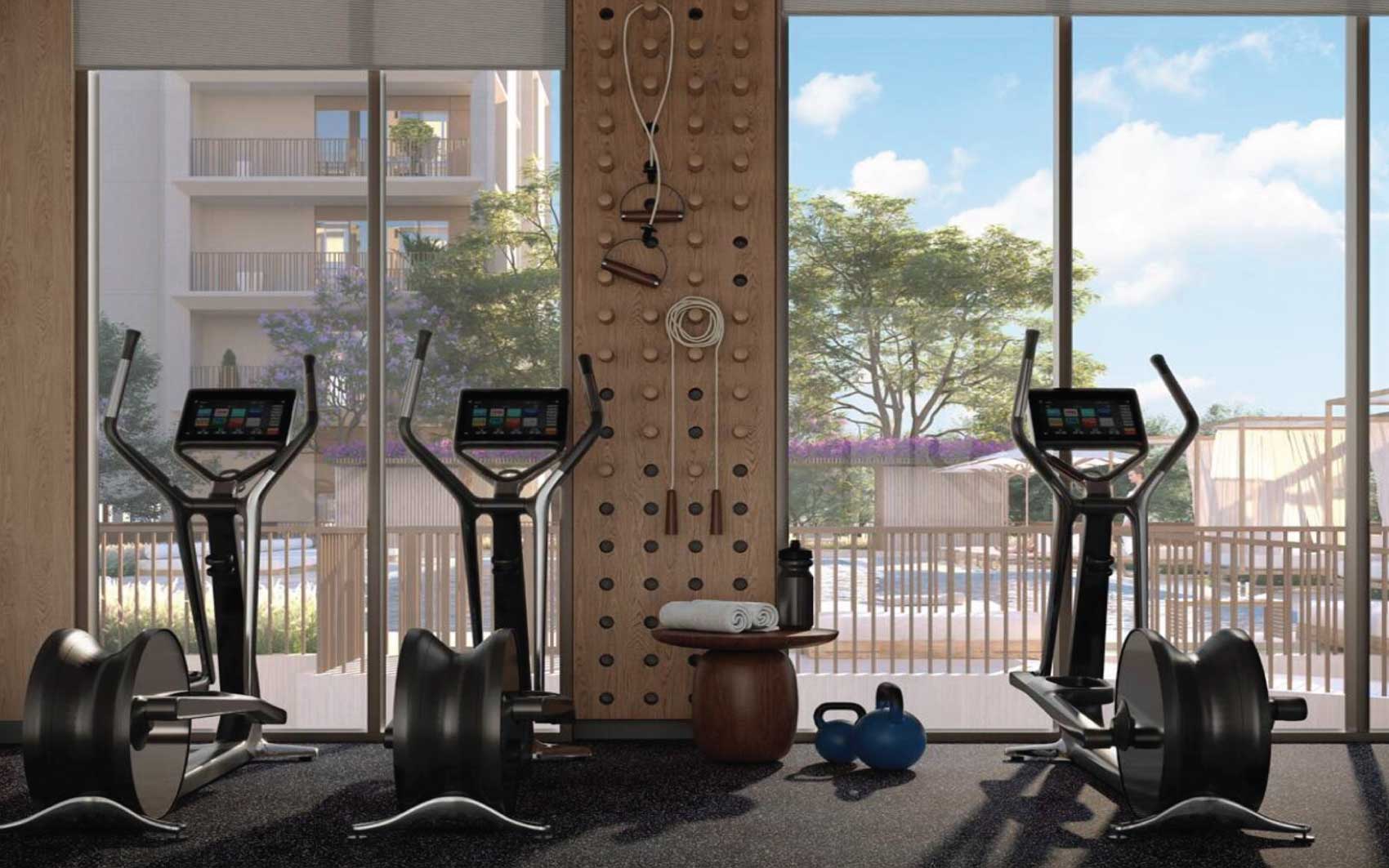 State-of-the-art gym with cardio machines, kettlebells, and natural light views