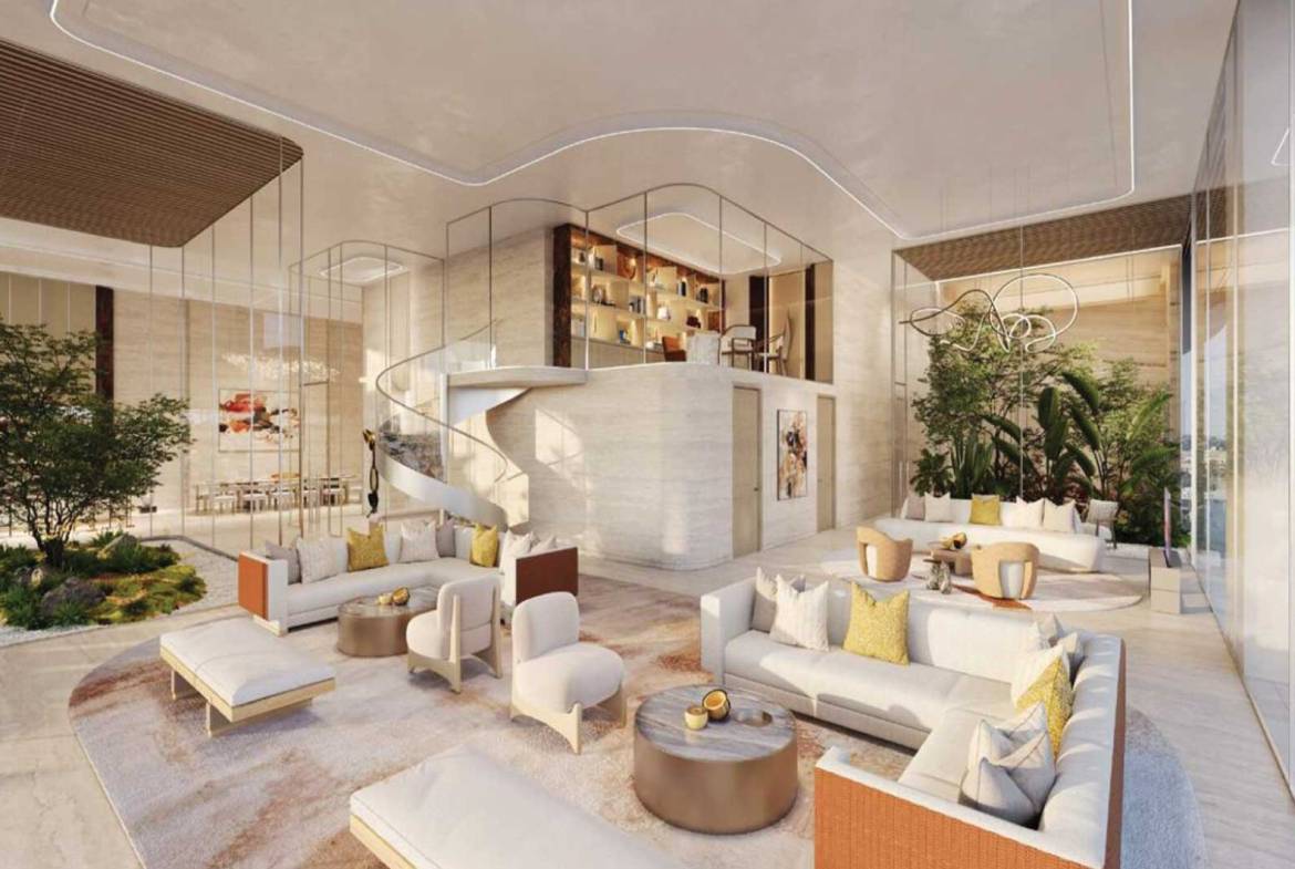 Spacious luxury lobby with indoor garden, curved staircase, and modern white sofas