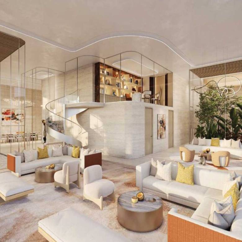 Spacious luxury lobby with indoor garden, curved staircase, and modern white sofas