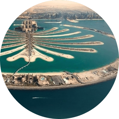 Palm Jumeirah in Dubai, showcasing its iconic palm-shaped island and luxury resorts against a clear blue sky